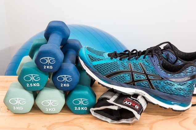 Apartments in Northwest Houston North On a wooden table, there is a pair of Asics shoes and a pair of dumbbells.