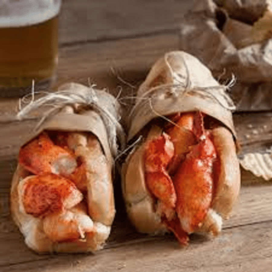 Apartments in Northwest Houston North Two lobster rolls with chips and beer on a wooden table in Northwest Houston North.