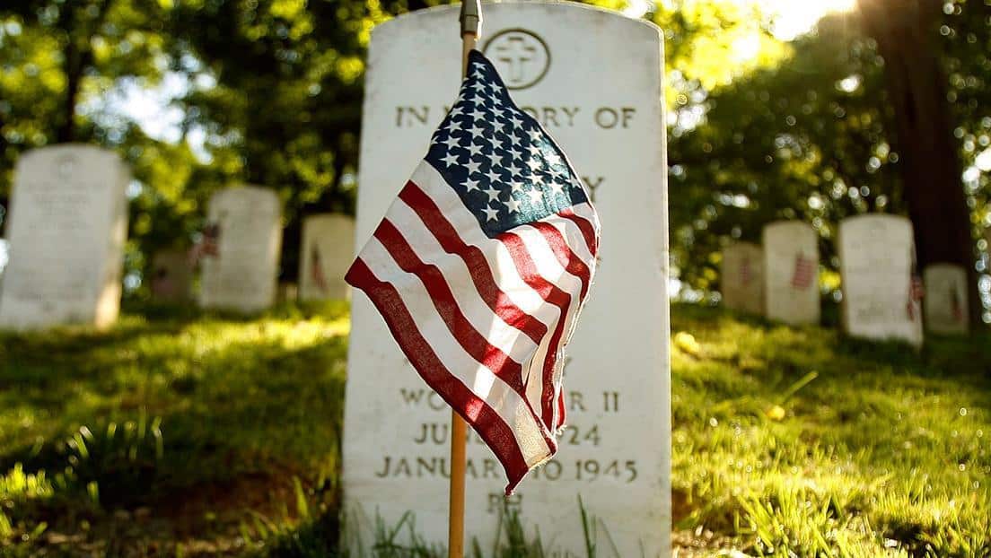 Apartments in Northwest Houston North An American flag proudly adorns a grave in a cemetery.